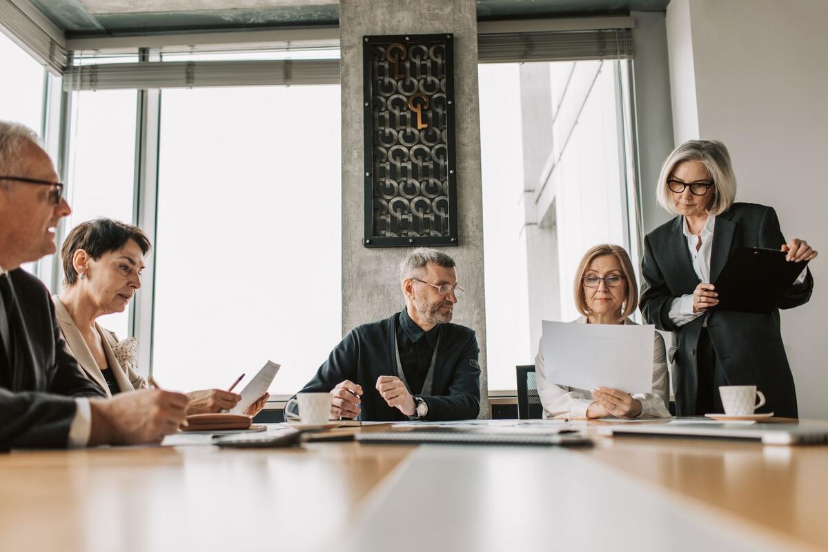 Senior professionals reviewing documents together around a conference table